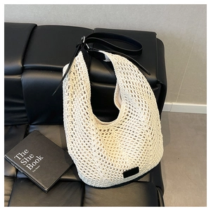 Detailed shot of mesh woven tote bag with adjustable black leather shoulder strap