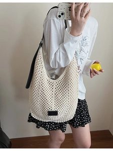 Chic cream hollow woven shoulder bag with black leather strap and large capacity design