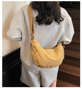 Macro view of the ginger yellow dumpling crossbody bag with premium nylon texture