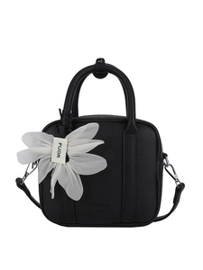 Minimalist black Boston handbag in litchi leather with a white flower charm and strap