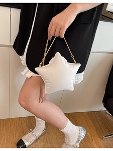 Unique white star shaped crossbody bag with gold chain strap and elegant quilted texture
