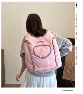 Detailed back view of pink quilted backpack featuring a heart-shaped pocket and embroidery