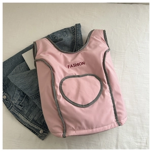 Detail view of pink quilted backpack with heart pocket and FASHION embroidery