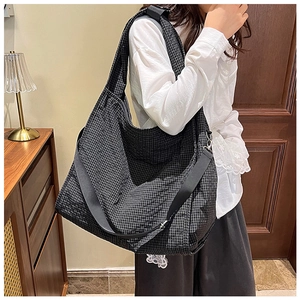 Detail of large capacity canvas tote bag with black and white checkerboard pattern texture