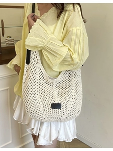 Handcrafted cream crochet tote bag with black leather shoulder straps and geometric mesh