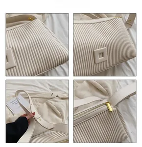 Detailed views of a beige pleated pillow bag featuring gold hardware and wide leather strap