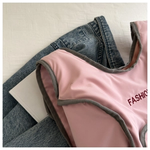 Detail of pink fashion vest with red FASHION embroidery and contrast grey fabric binding