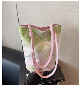 Detail of pink and green marbled canvas bucket bag showing fabric texture and HOOG label