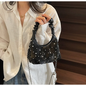 Detail of black pleated crescent bag with rhinestones and silver chain strap