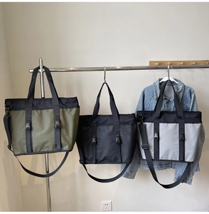 Detailed comparison of three nylon tote bags in green, black and grey with buckle straps