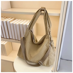 Close-up of khaki gingham canvas tote bag with adjustable strap and metal hardware