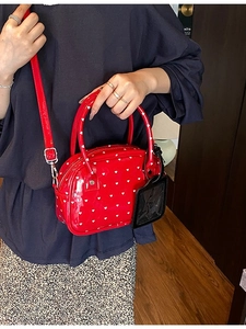 Red glossy heart-print bowling bag for women with top handles and slender shoulder strap