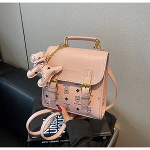 Pink PU leather backpack with bear print, metal handle and matching bear charm detail