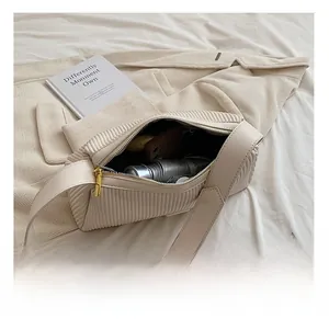 Detailed view of the pleated cream shoulder bag interior showing spacious capacity for items