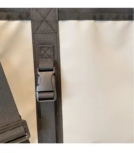 Detail of minimalist canvas bag with durable black strap and plastic buckle adjustment