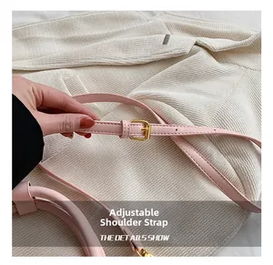 Detailed view of the pink PU leather adjustable shoulder strap with gold metal buckle