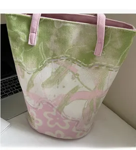 Detail showing high-quality canvas fabric texture and floral pattern on a tote bag
