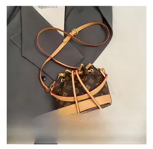 Detail of the Monogram bucket bag showing the drawstring closure and red oil edge finish