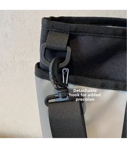 Detailed view of the detachable swivel hook and D-ring on the canvas crossbody strap