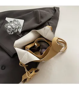 Top view of yellow bucket bag showing spacious interior with zipper pocket and cosmetics