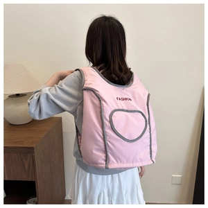 Detail of pink quilted backpack with FASHION text and heart outline graphic on fabric