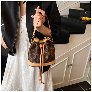 Detail of vintage monogram bucket bag with drawstring closure and leather handle