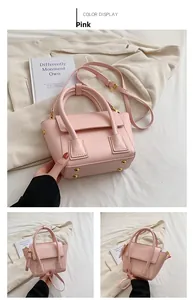 Detailed view of a pink matte leather bucket bag with gold hardware and studs