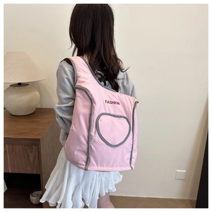 Macro view of a quilted pink backpack with heart-shaped pocket and fashion embroidery