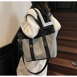 Detail of high-capacity nylon tote bag with functional buckle and adjustable strap