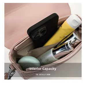 Internal capacity of pink leather handbag with herringbone lining and zippered pocket