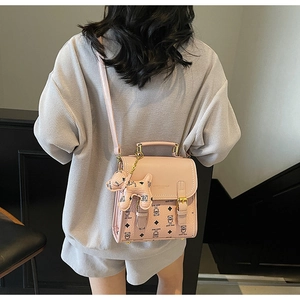 Close-up of pink Teddy Bear printed PU leather bag with cute puppy charm accessory