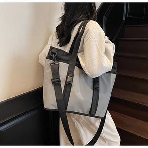 Detailed view of grey and black large capacity crossbody bag with functional buckles