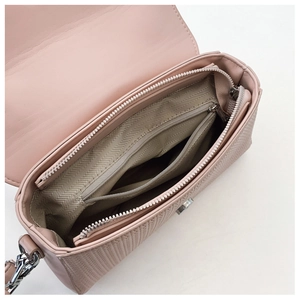 Detail view of pink crossbody bag interior with herringbone lining and zippered pocket