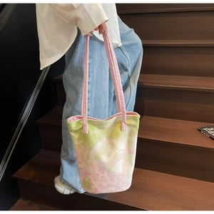Detailed macro view of the watercolor floral canvas bucket bag with pink shoulder straps