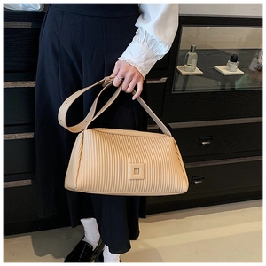 Detail of cream pleated crossbody bag with square buckle and adjustable shoulder strap