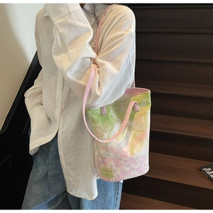 Detail of floral canvas tote bag with pink round handles and artistic flower print