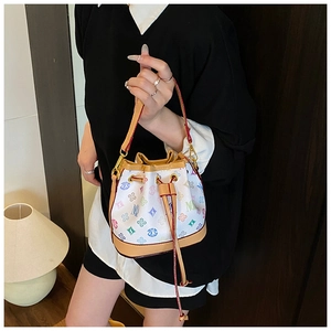 Detailed close-up of a mini bucket bag featuring colorful letters and brown leather trim