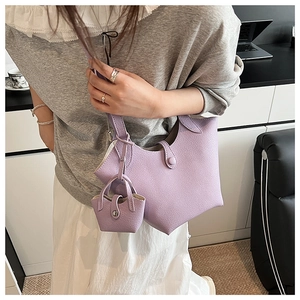 Detail of lilac bucket bag with lychee texture and matching mini charm pouch