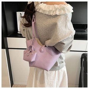 Detailed view of lavender purple bucket bag in lychee pattern faux leather with pouch