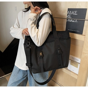 Detailed view of black large capacity commuter tote bag with adjustable shoulder strap