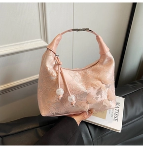 Detail of light pink embroidered bag with mesh butterfly appliques and pearl beads