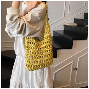 Macro view of bright yellow hollow knit tote bag showing intricate woven texture and lining