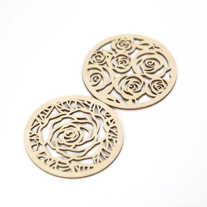 Set of two round wooden coasters with laser-cut rose floral patterns on a white background
