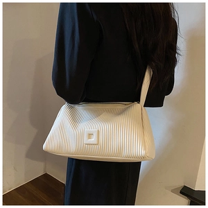 Close-up detail of cream white pleated shoulder bag with square buckle and zip closure