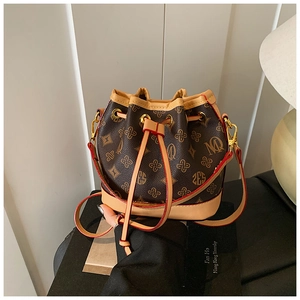 Detail of vintage bucket bag with monogram canvas, drawstring closure and gold hardware