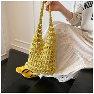 Detail showing bright yellow hollow knit tote bag with thick cotton rope and inner pouch