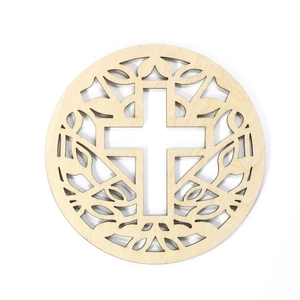 Macro shot of laser-cut wooden coaster showing intricate cross and leaf patterns