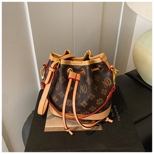 Detail of vintage monogram bucket bag with drawstring closure and leather shoulder strap