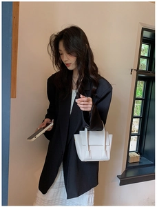 White PU leather trapeze handbag styled with a black blazer and lace skirt outfit