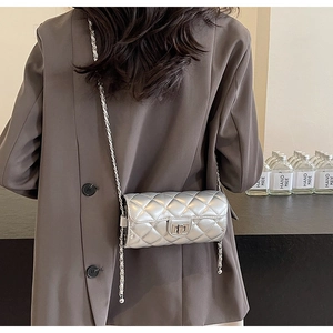 Detailed back view of a silver quilted pillow bag with mirror finish and metallic chain